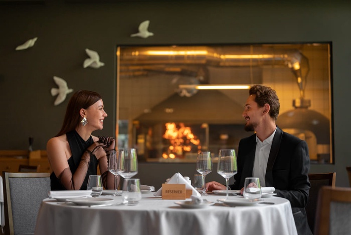 medium shot couple having lunch in luxury restaurant